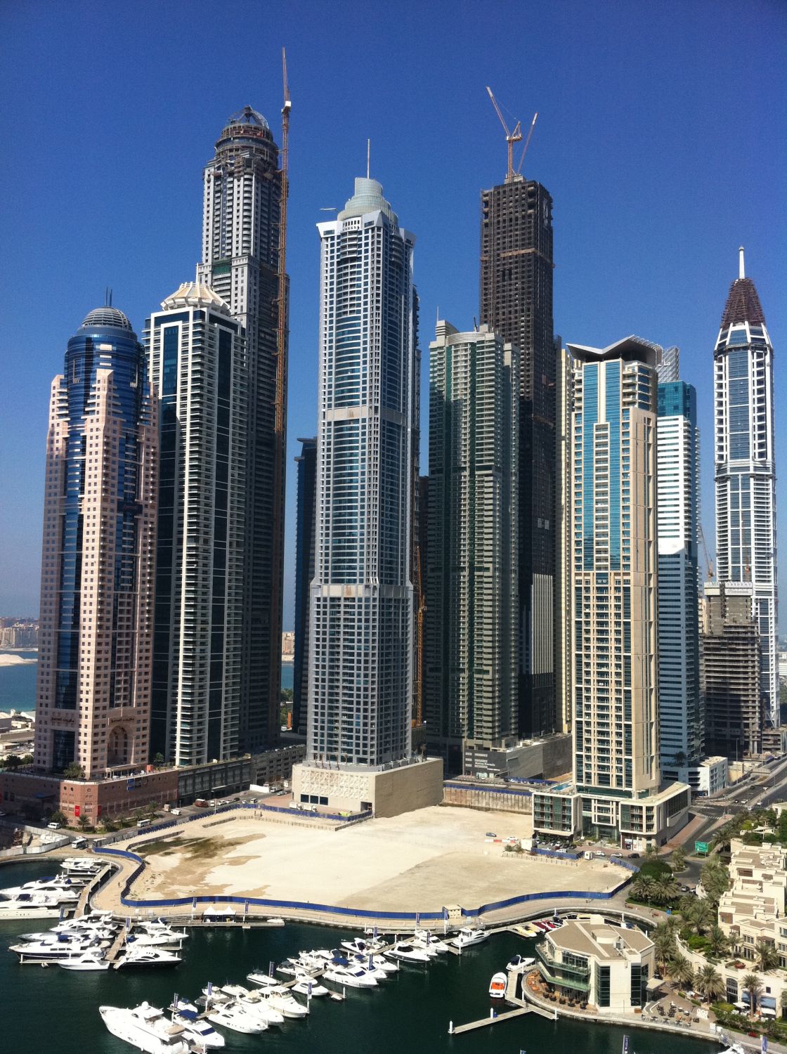 Dubai Marina towers under construction above the yacht harbour