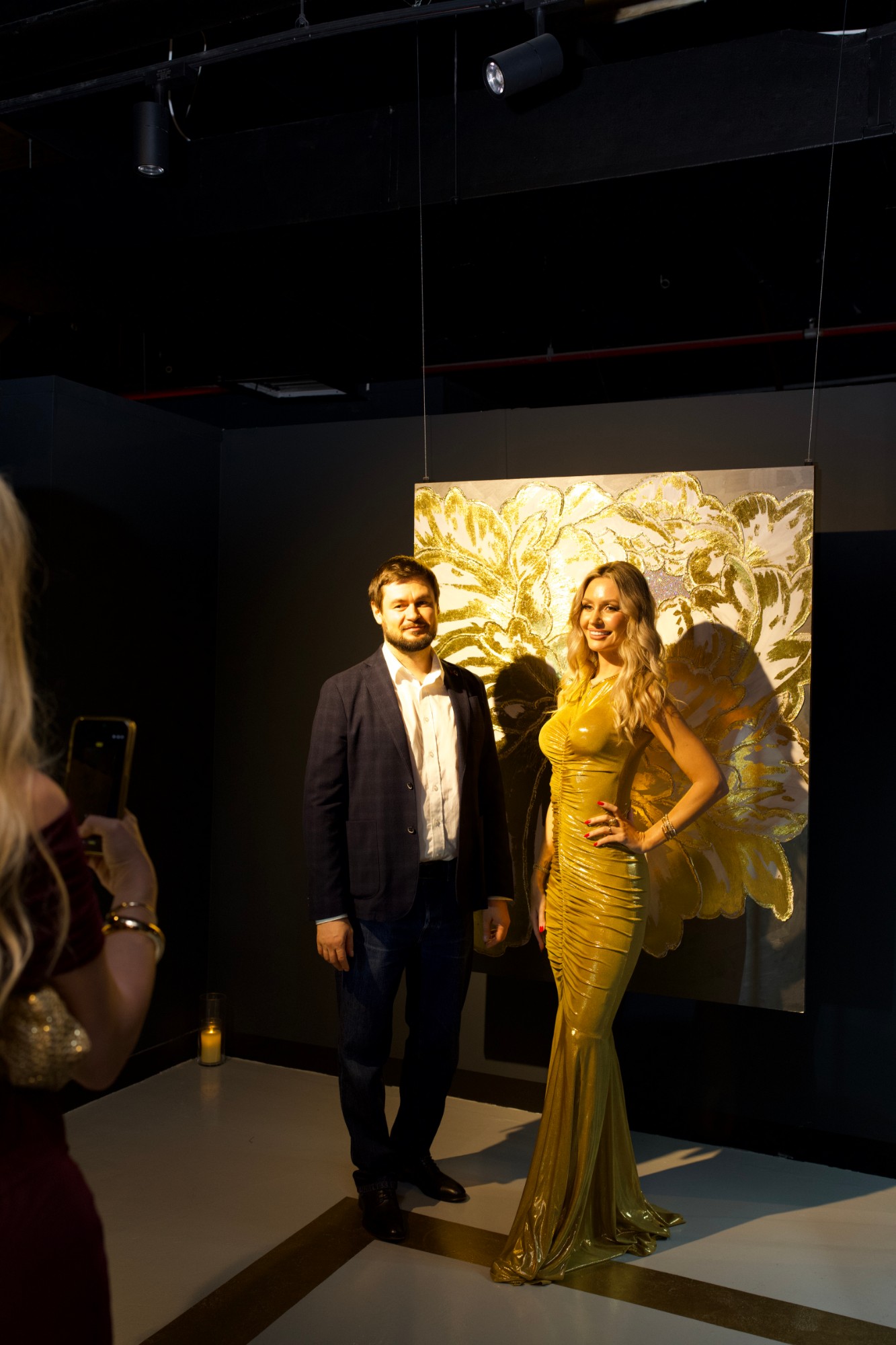 Roman Chertkov and Oksana Vildanova in front of a gold-leaf painting