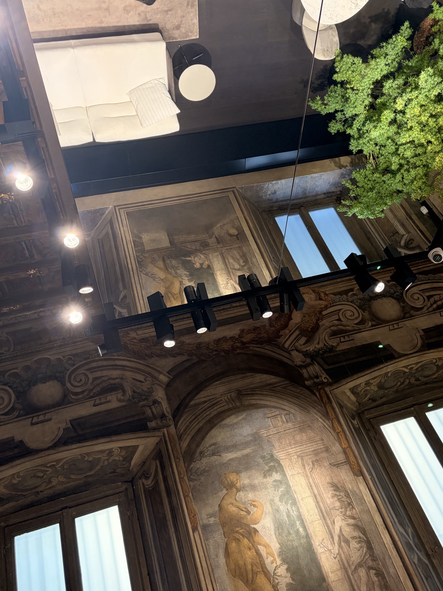 Furniture stand under the frescoed ceiling of a Milan palazzo