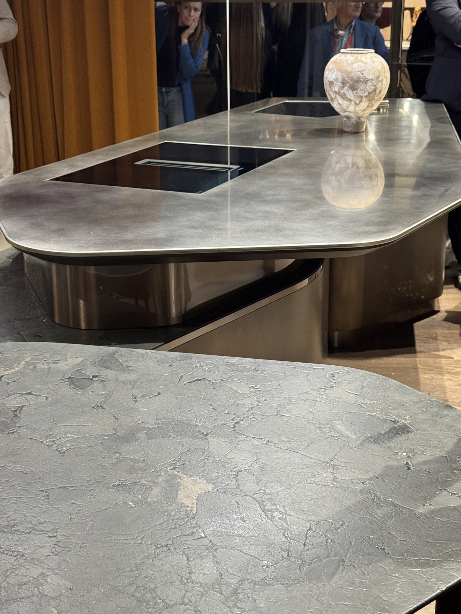 Steel kitchen island with a stone worktop at an exhibition stand