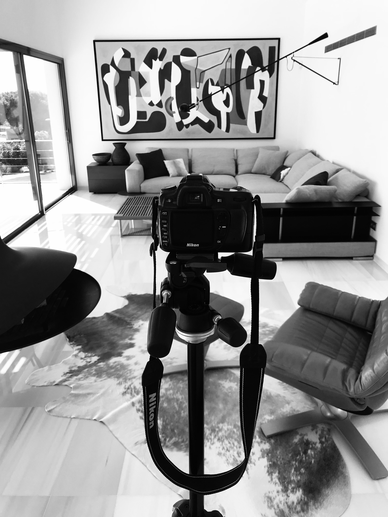 Camera on a tripod in a living room during an interior shoot