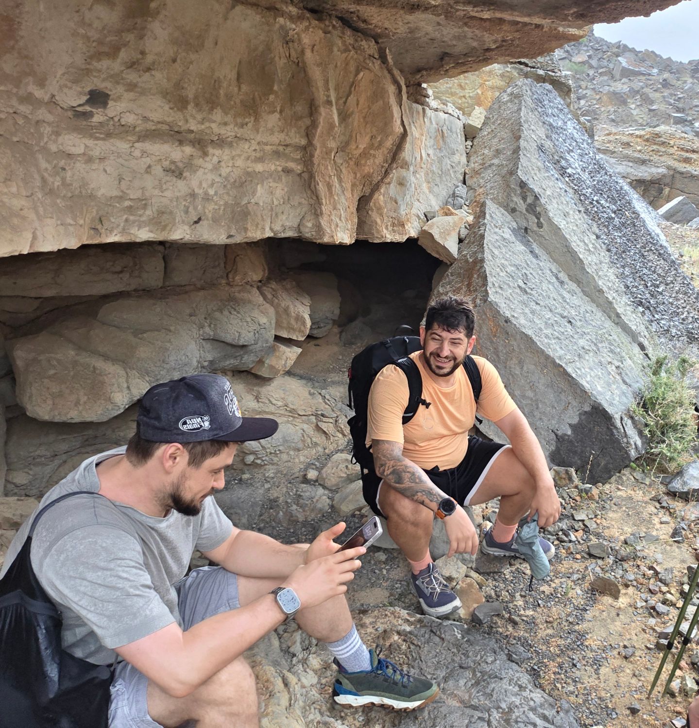 Roman Chertkov and a friend resting under an overhanging rock