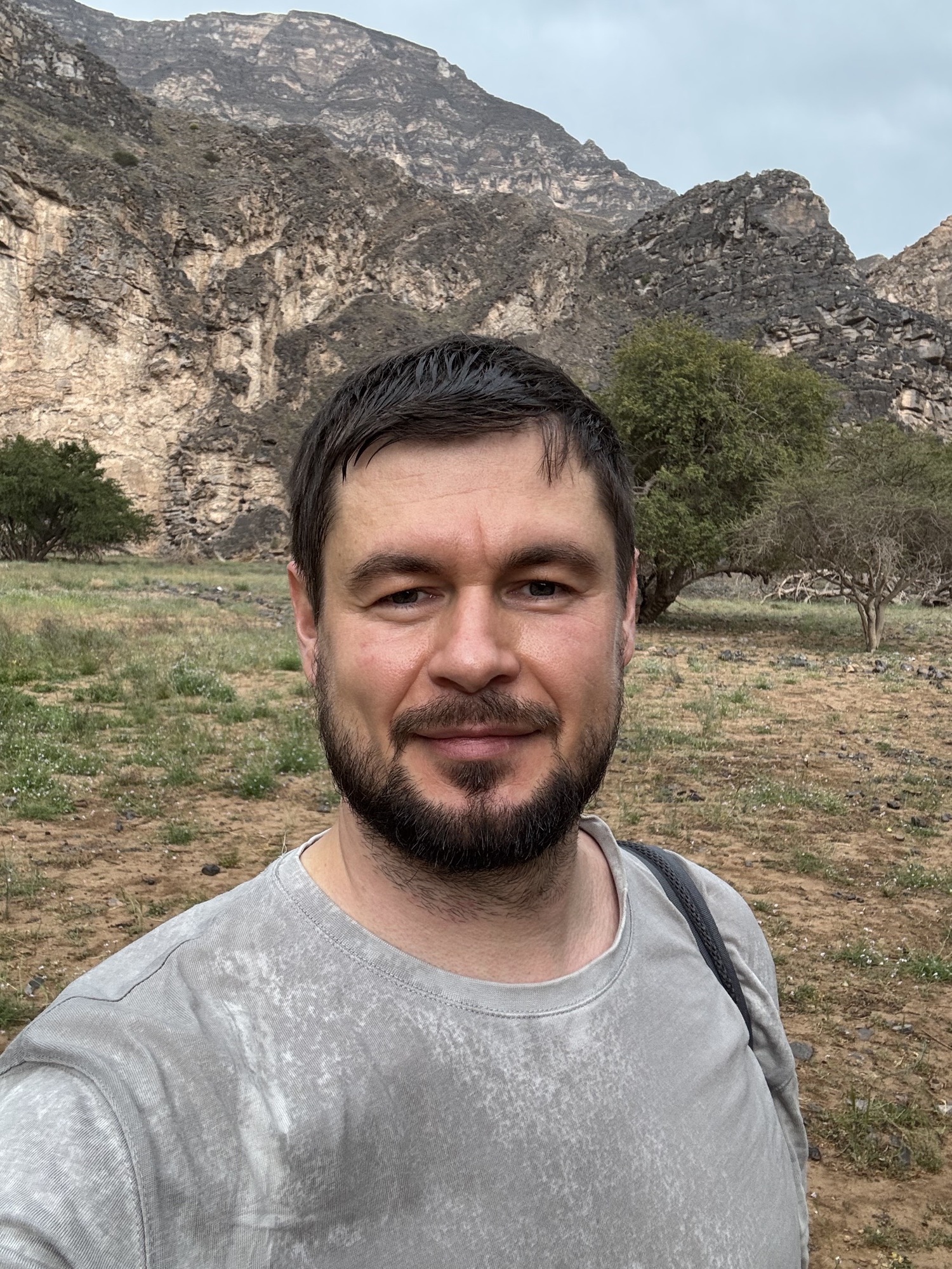 Roman Chertkov, portrait with mountains and trees behind